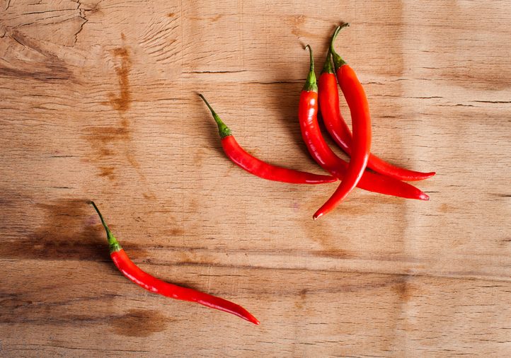 Red fresh chili on wood desk. Food background. Cooking