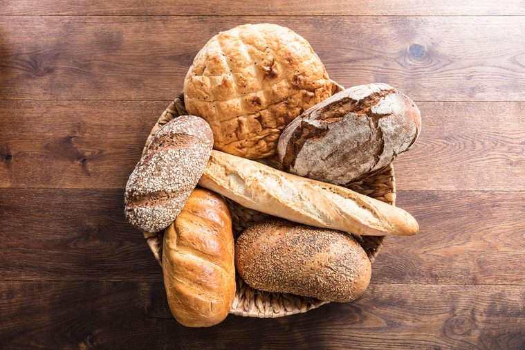 High Angle View Of A Variety Of Freshly Baked Bread In The Wicker Basket