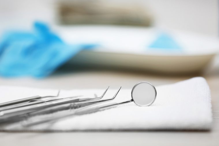 Set dentist tools on napkin on table close up