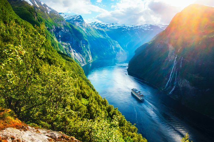 Breathtaking norway view of Sunnylvsfjorden fjord with cruise ship and famous Seven Sisters waterfalls, near Geiranger village in western Norway. 