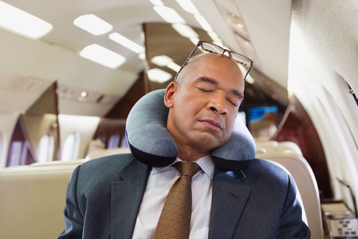 Businessman sleeping in private jet