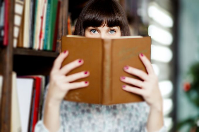 Image of young brunette with book in hand