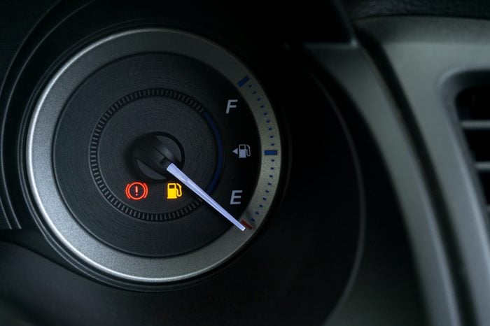 Detail with the fuel gauges showing and empty tank on dashboard of car