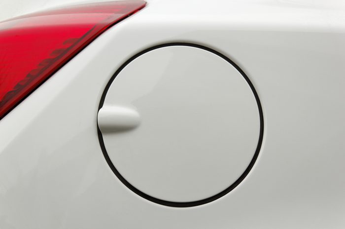 A close up of a petrol cap cover on a modern white car