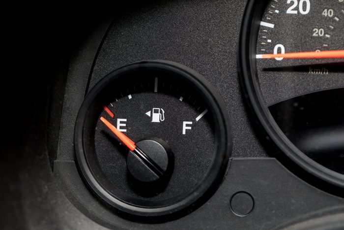 Low fuel guage shown in a car shot close up
