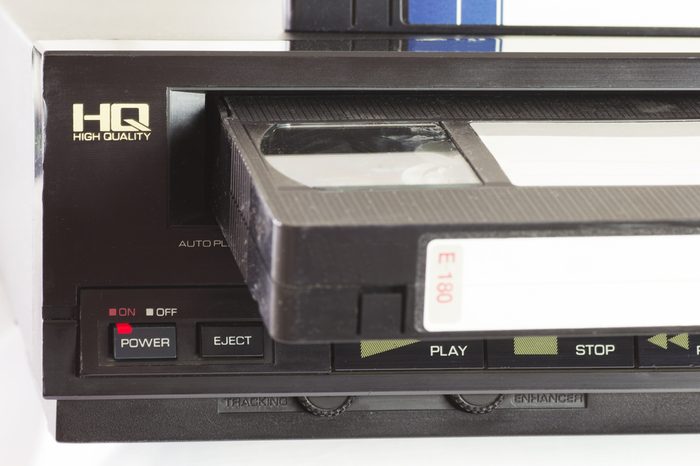 Old VHS Video Cassettes and Old Video Recorder. Closeup. 