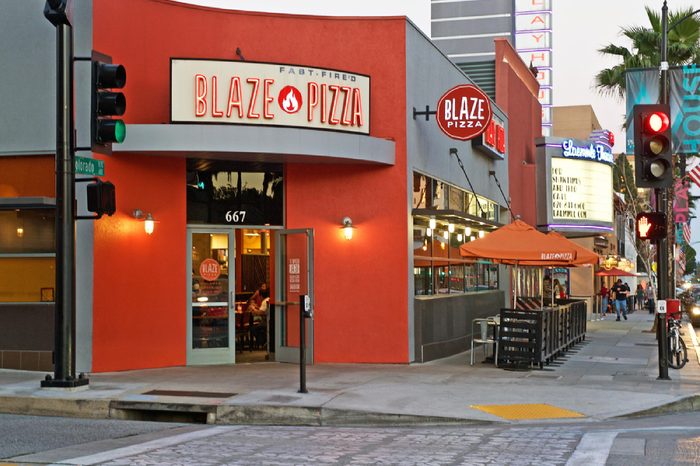 Building facade of the popular Blaze Pizza restaurant. Image was captured after sunset in Pasadena, California USA