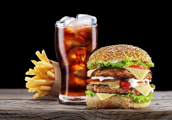 Hamburger, potato fries, cola drink. Takeaway food. Fast food.