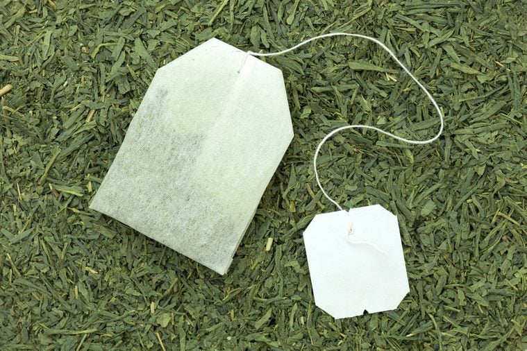 green tea bag on tea leaves