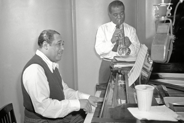 Louis Armstrong, Duke Ellington. Jazz trumpeter Louis Armstrong and pianist Duke Ellington rehearse Leonard Feather's song "Long, Long Journey" at the RCA Victor recording studio in New York City on . This is the first time Armstrong and Ellington have made a recording together