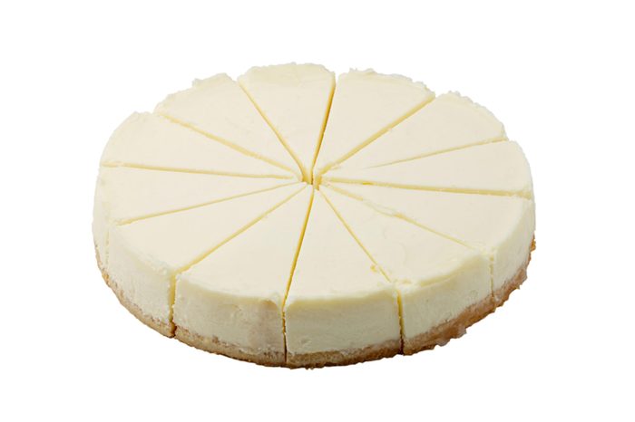 plain cheesecake on white background isolated, cuted in equal parts circle