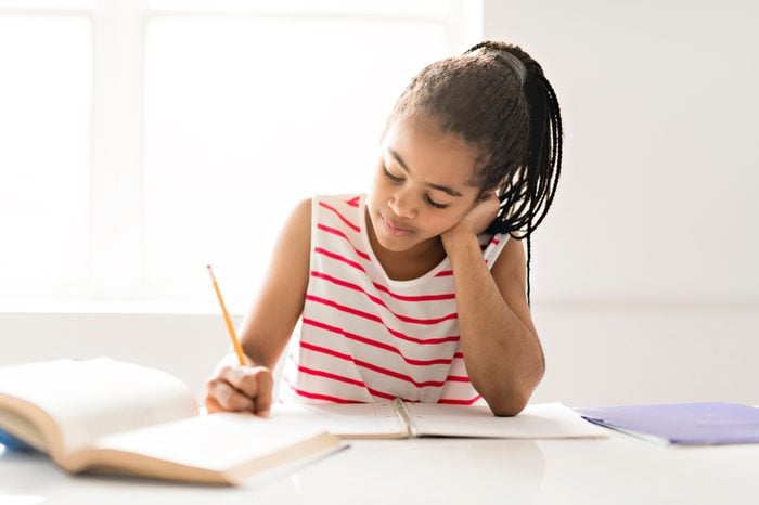 Black girl doing homework at home