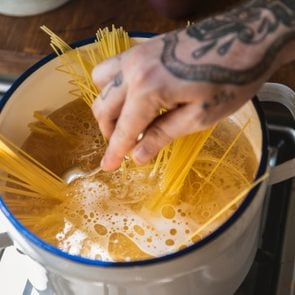 A chef boiling capellini pasta in the pot