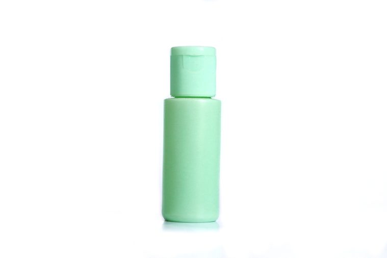 pastel green plastic lotion bottle and white background isolated