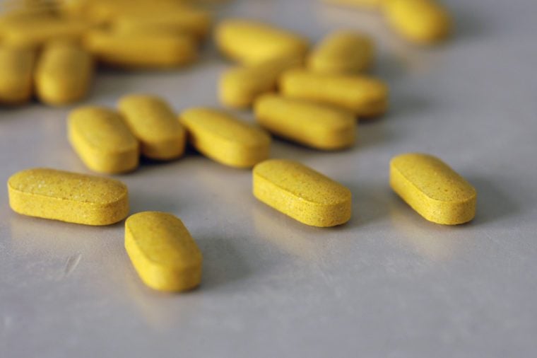 Tablets of B-complex vitamins scattered on a table