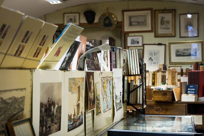 An old vintage shop selling second hand books and antique paintings.