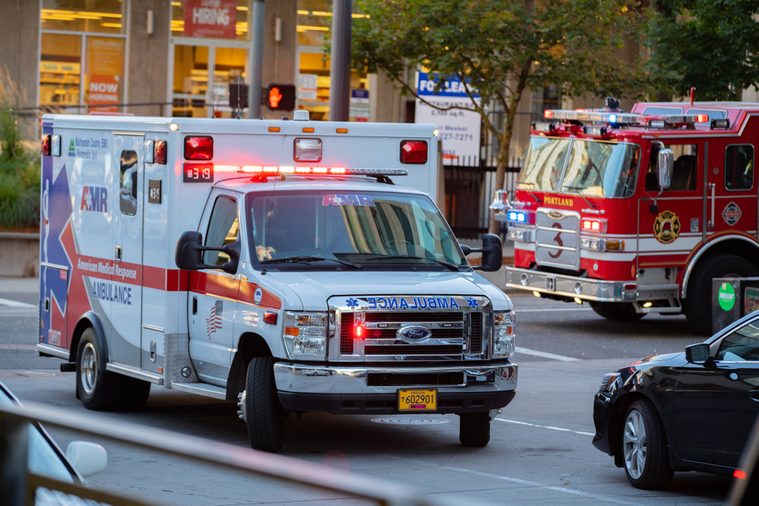 Ambulance and firefighter trucks block the street in downtown.