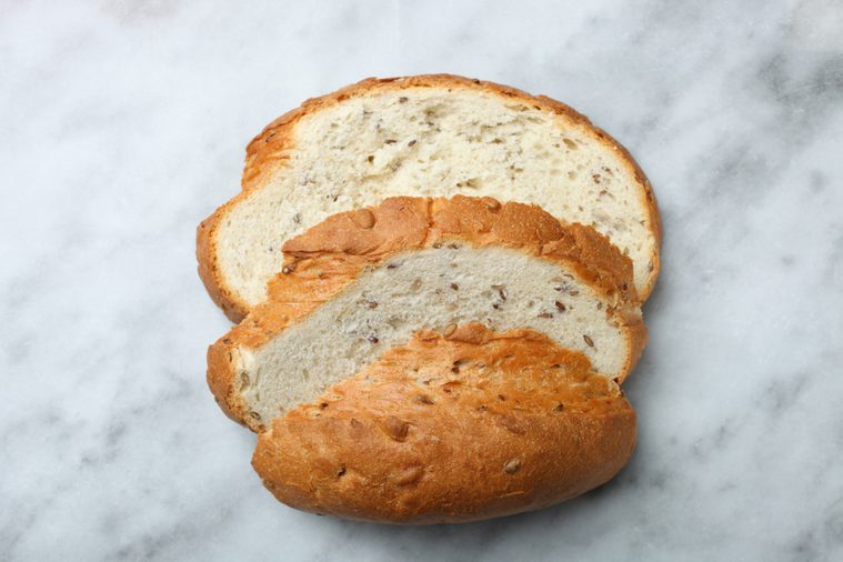 White bread with seeds on a marble background. Top view.