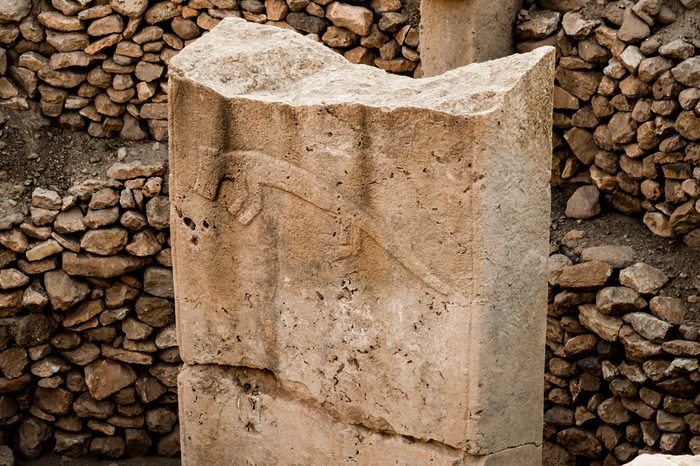 Stylised carvings at Gobekli Tepe archaeological site at the top of a mountain ridge in the Southeastern Anatolia Region of Turkey.