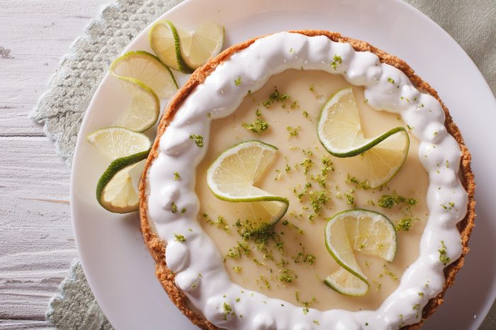 key lime pie with whipped cream close-up on a plate. horizontal view from above