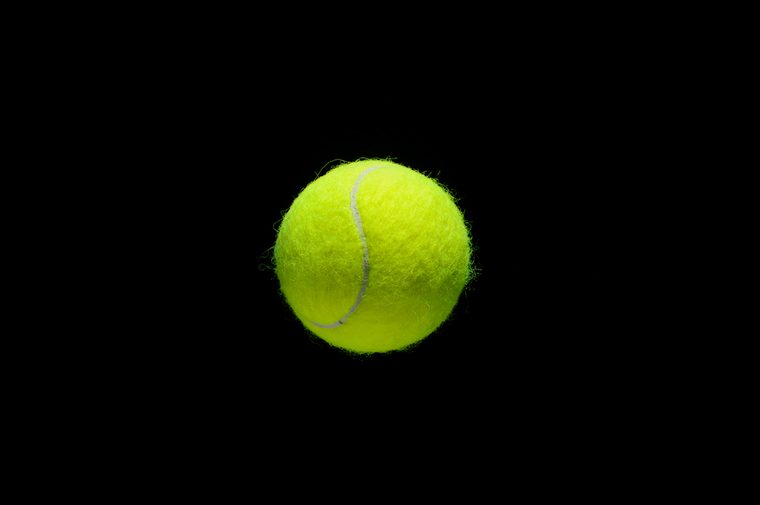 tennis ball over black background