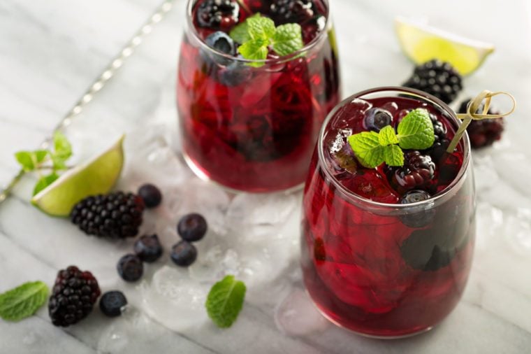 Cold summer berry drink with lime and blackberries