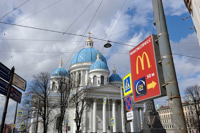 St.Petersburg, Russia - April 23, 2016: view of Trinity Cathedral and a pointer to the McDonald's in St. Petersburg, Russia