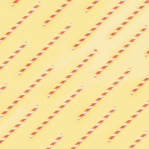 pattern of white and red drinking straw on yellow background