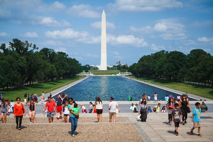 WASHINGTON, D.C. - JUNE 11, 2014: People enjoy sunny day in front of Lincoln Memorial with Washington Monument in the background.
