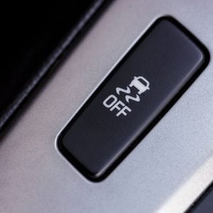 Slippery button. An image of a button for traction control in a modern car