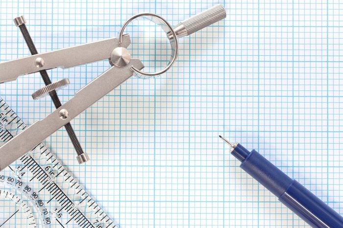 Still life photo of engineering graph paper with a fine 0.1mm pen, compass and ruler blank to add your own design, image or text.