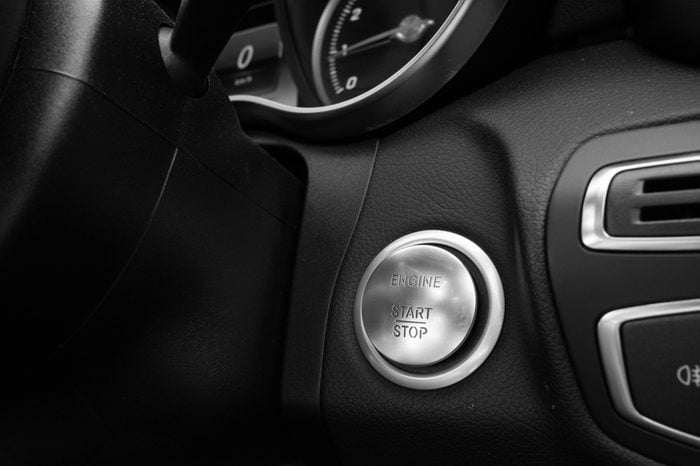 Start Stop Engine button in luxury car in black and white photography
