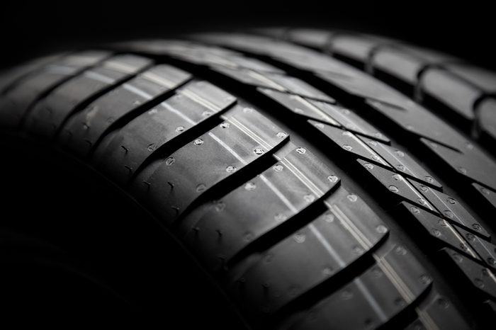 sport car tire detail on black background