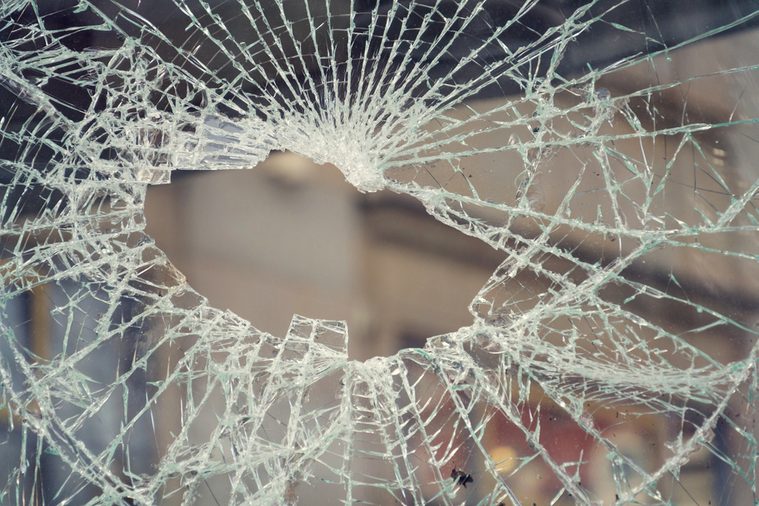 Hole in broken shattered security glass, insurance, security, vandalism or crime concept, shape of Czech Republic