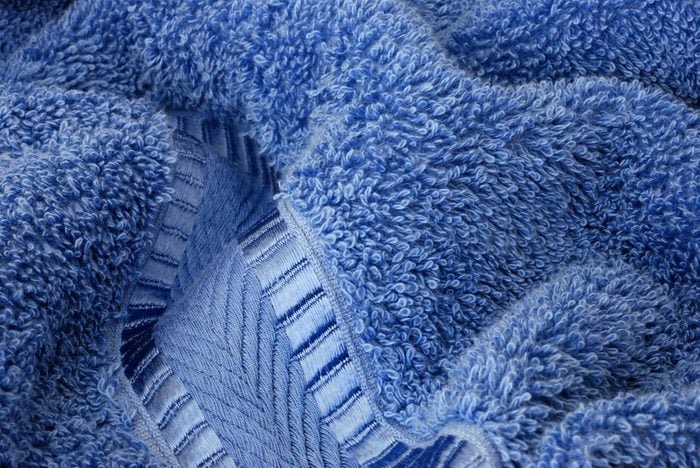 Macro image showing texture and details of a plush, terry cloth bath towel.