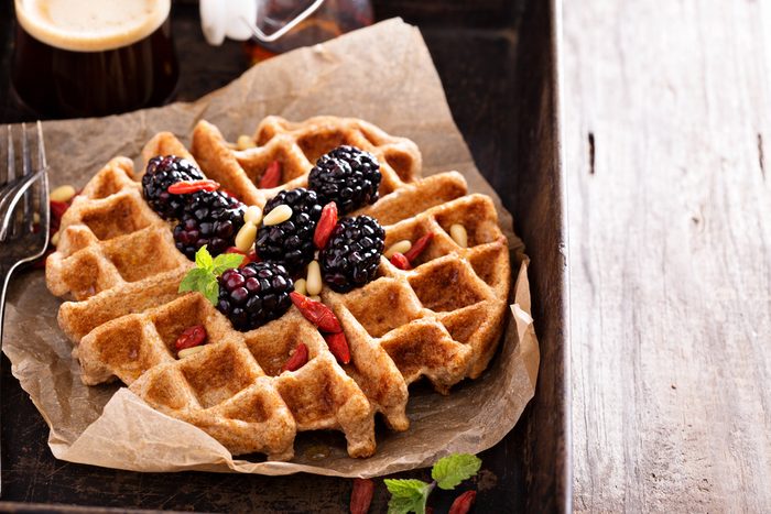 Whole wheat breakfast waffle served with blackberries and goji berries