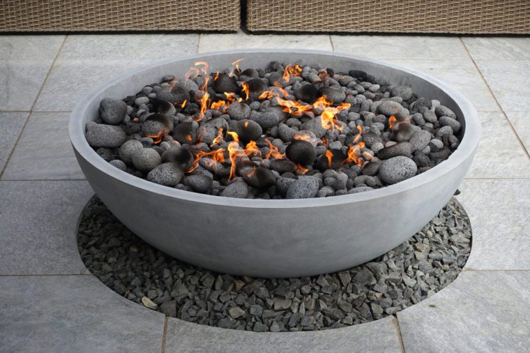 modern fire pit on backyard patio 