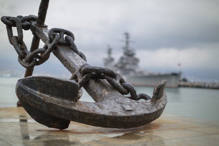 Anchor on the embankment and the cruiser "Mikhail Kutuzov" in the port of Novorossiysk, Russia