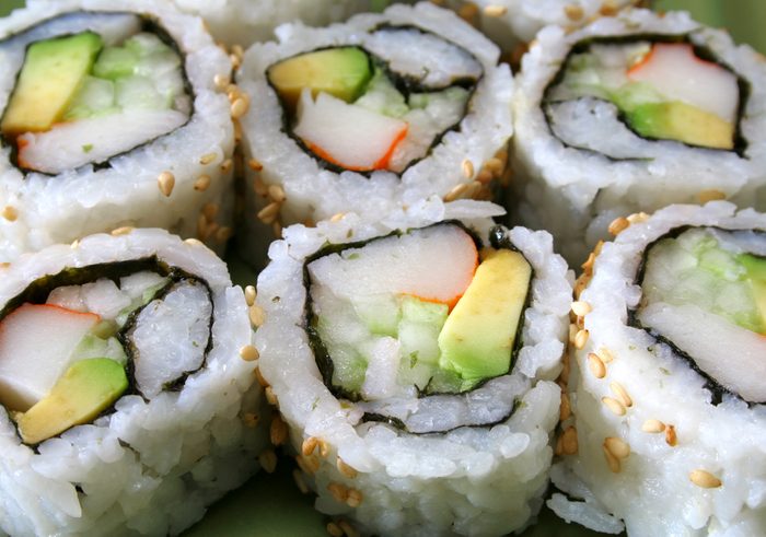 a row of sushi/ California rolls