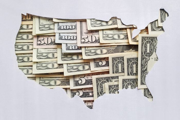 cut out map of the united states with u.s. money bills in negative space