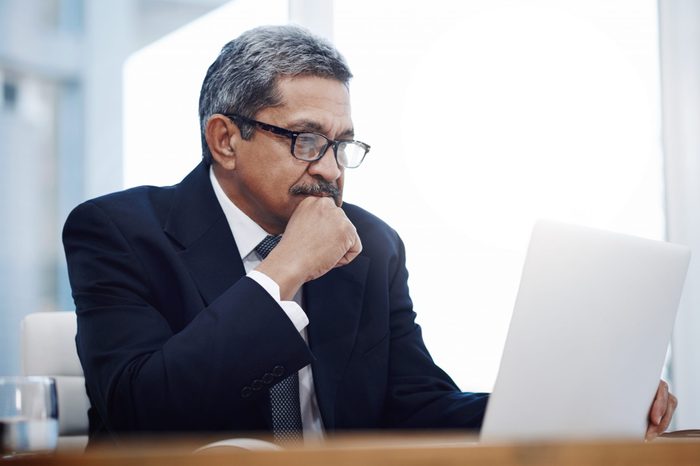 Shot of a mature businessman working on a laptop in an office