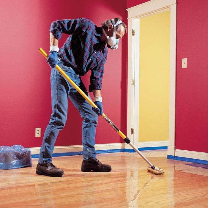 man finishing hardwood floors