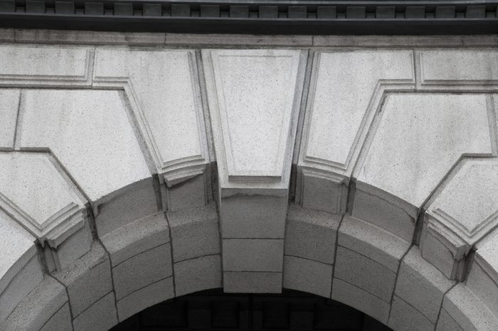 A closeup of keystone, architecture design that is above a doorway entrance.