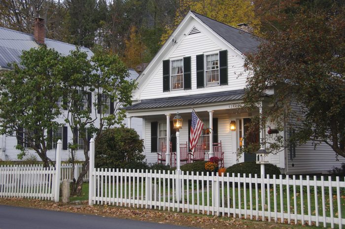 White clapboard house with a white picket fence