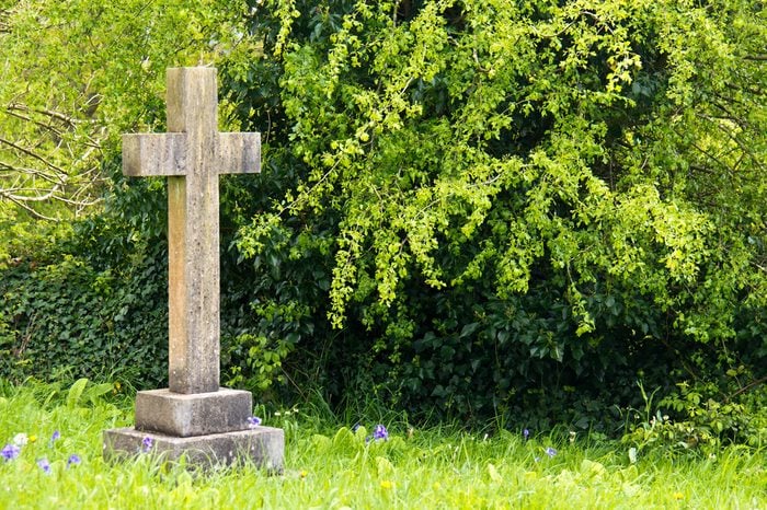 Single cross headstone in graveyard