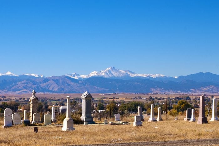 Small, old graveyard with view of Rocky Mountains and a small Colorado town