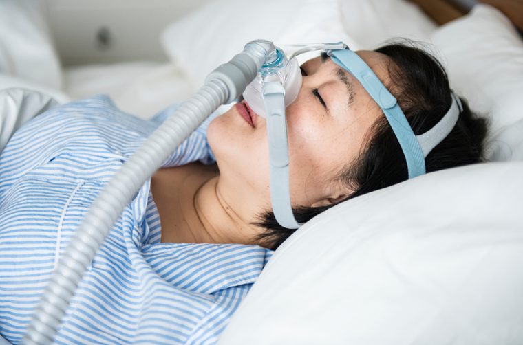 A woman wearing anti-snoring chin straps