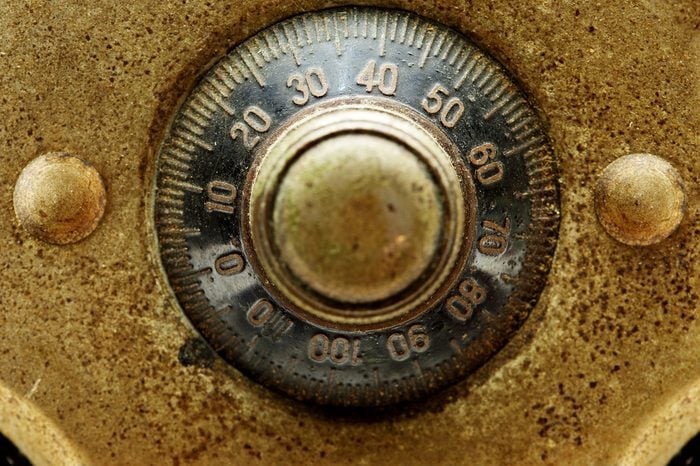 Early 1900s dial combination lock close up. Black dail and gold plate.