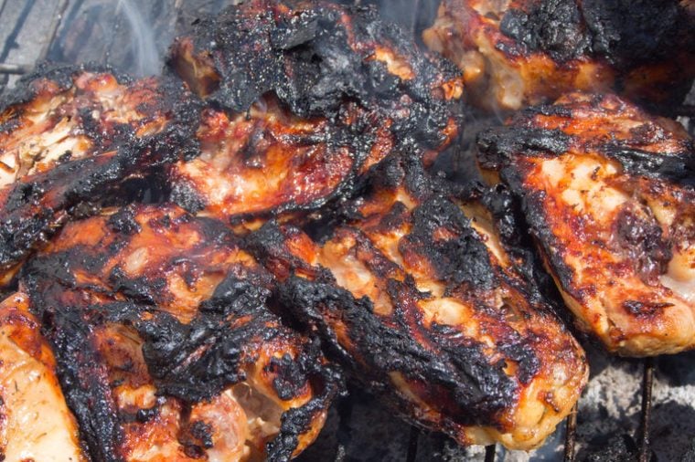burnt, charred chicken on a barbecue