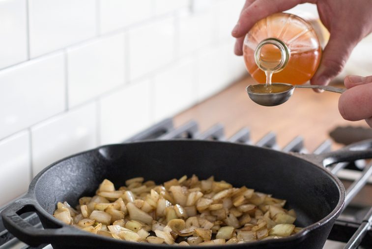 Measuring apple cider vinegar for caramelized onions